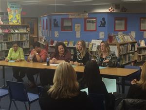 classroom of parents in front of panel 